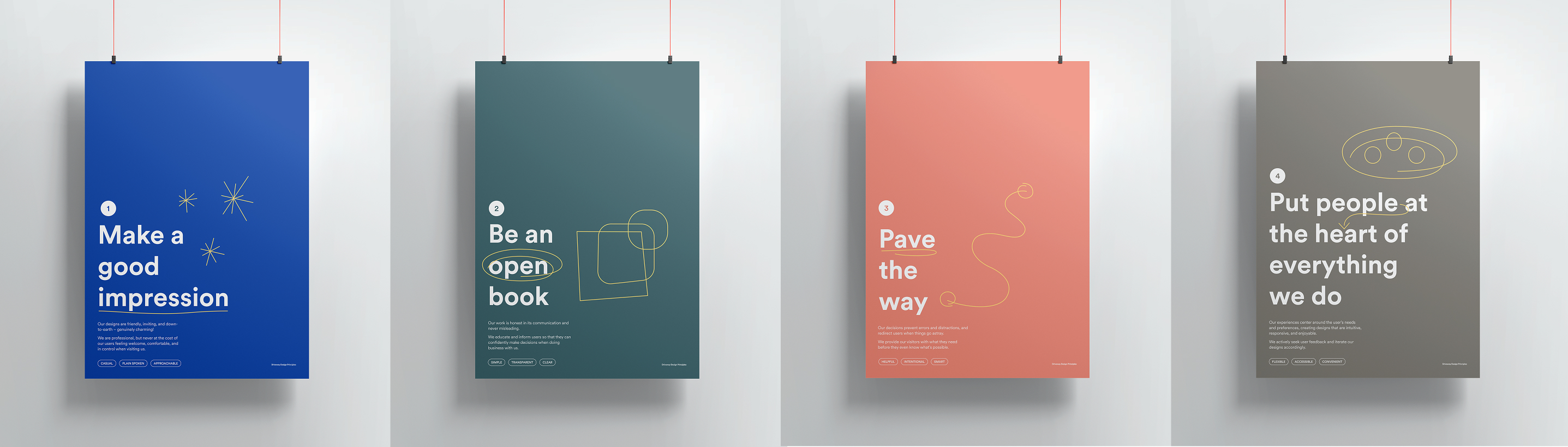Four solid-colored printed posters displaying the principles.